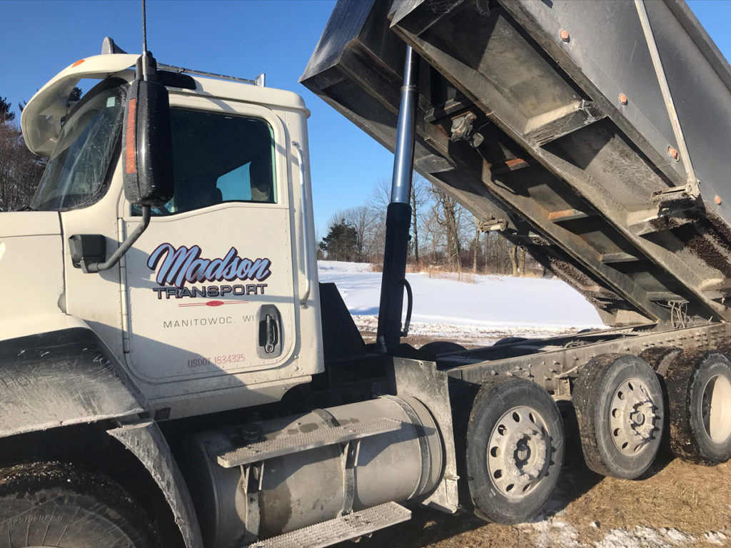 a dump truck with the word Madison on the door