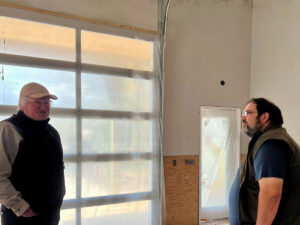 two men inside of a building under construction