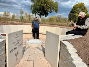 two men in an outdoor meeting circle made of stone