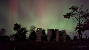 The Northern Lights (pastel colored night sky) over the 3 ivy wall towers at the Arboretum.